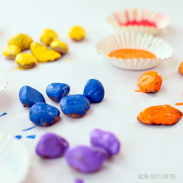 Painted stone rainbow craft for kids. Celebrate spring with a fun and easy craft for toddlers and older kids. | at Non-Toy Gifts