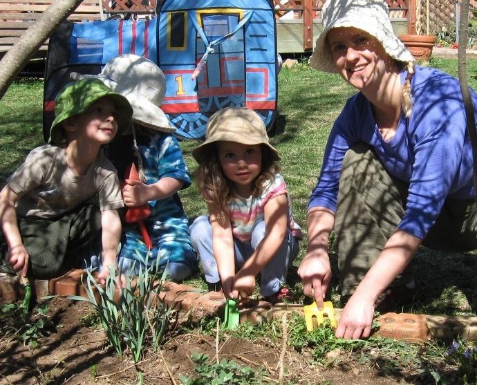 A group of people planting plants
Description automatically generated with low confidence