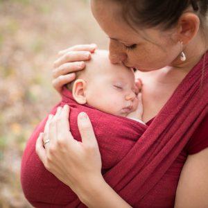 A person holding a baby

Description automatically generated