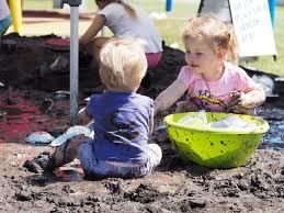 A couple of children playing in the sand
Description automatically generated with low confidence