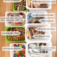 This may contain: several plastic containers filled with different types of beads and wooden blocks on a wood table