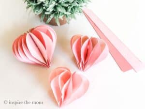 Pink Honeycomb hearts diy. www.inspirethemom.com