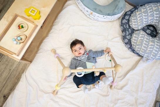 A baby lying on a bed

Description automatically generated with low confidence