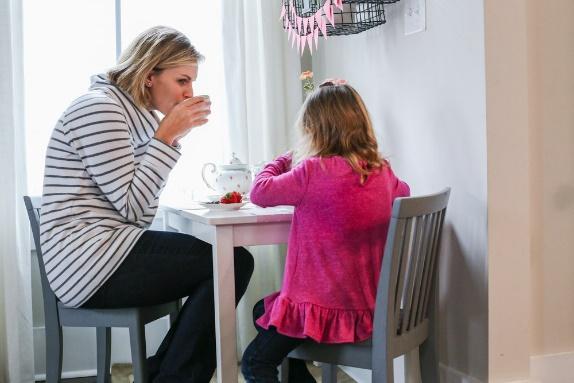 A person and a child sitting at a table

Description automatically generated with medium confidence