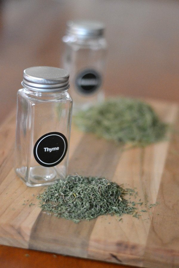 dried herbs sitting on a cutting board