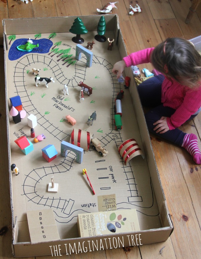 playing with train tracks in box