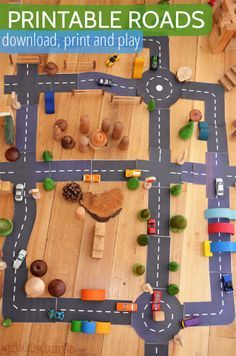 This may contain: an overhead view of a toy road with cars, trucks and trees on the roadway