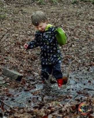 Enjoying himself playing in the creek