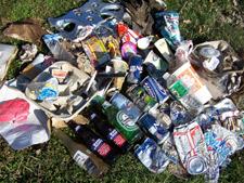 An assortment of plastic, glass, metal and other litter on the grass