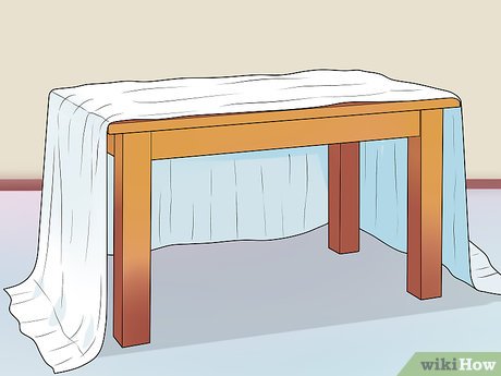 Step 3 Drape a blanket over a 4-legged table.
