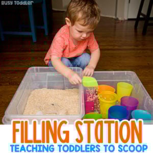 FILL IT UP STATION: Make a fun filling station for toddlers; taby activity; indoor taby activities; easy toddler activities; sensory bins; life skills; montessori life skills; teaching scooping by Busy Toddler