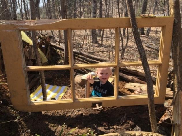 A baby in a wooden structure
Description automatically generated with low confidence