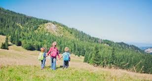 A group of people walking on a trail in a grassy area

Description automatically generated with low confidence