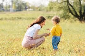 A person and a child playing in a grassy field

Description automatically generated with medium confidence