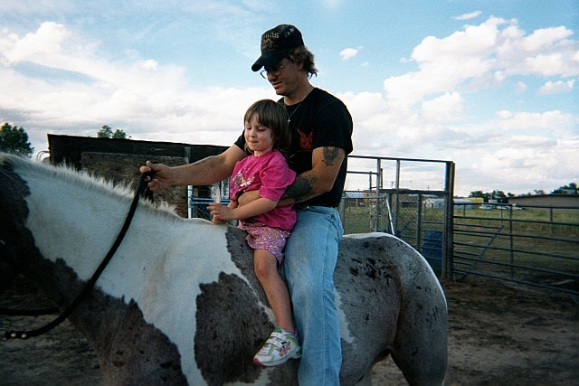 A person standing next to a horse

Description automatically generated with medium confidence