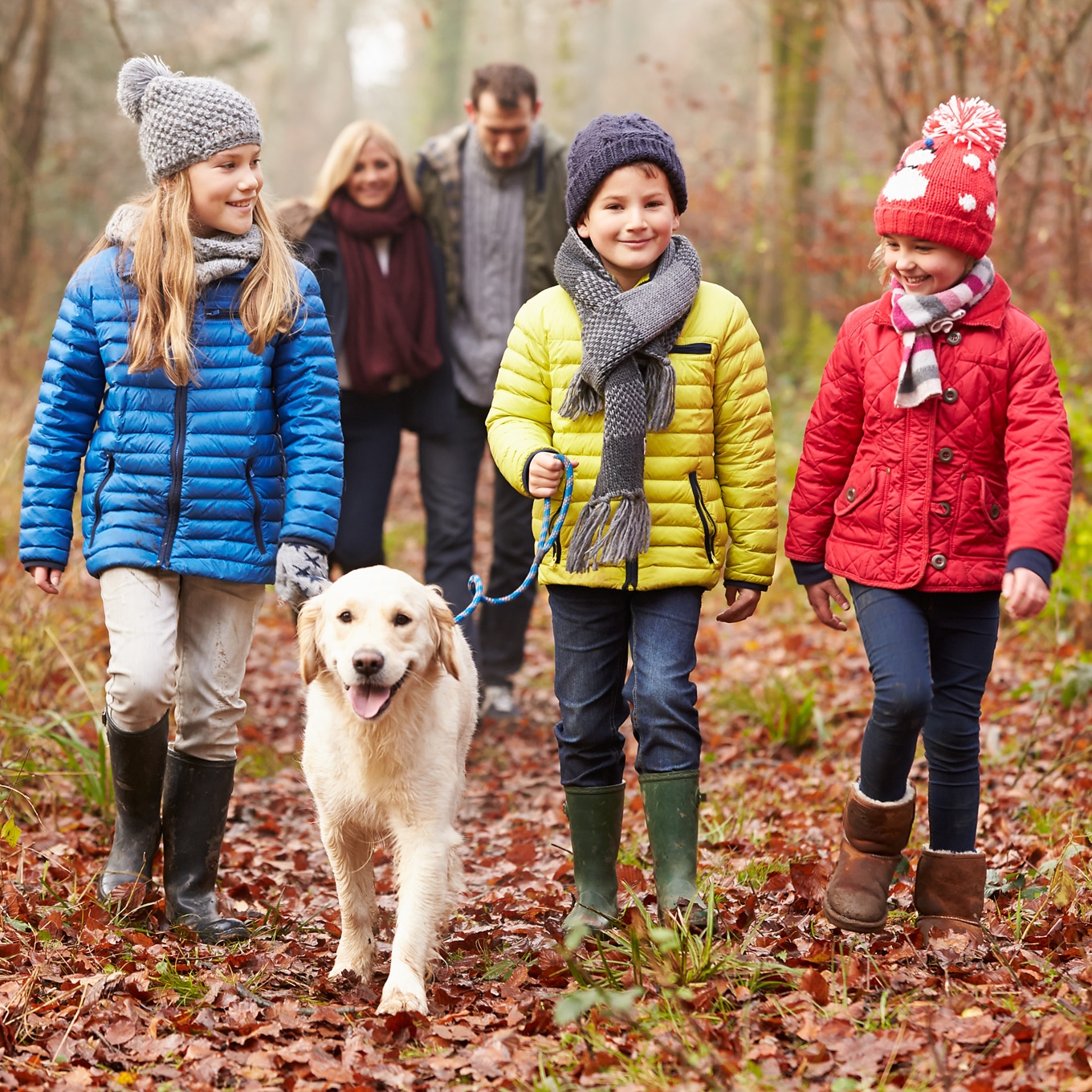 Happy Family Enjoying a Nature Walk with Dog