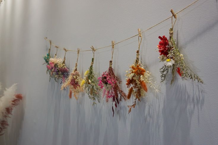 tied bunches of flowers hanging on pegs to dry
